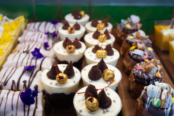 Assortment of delicious and colorful desserts made by pastry chef. All look very tasty and delightful. Natural light.