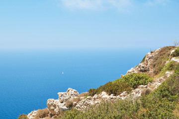 Lonely boat in the sea near Dingli cliffs. Malta