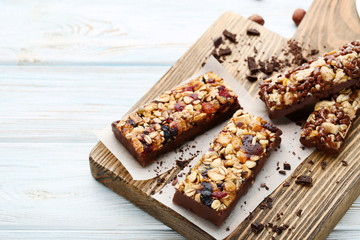 Granola bars with chocolate crumbs on cutting board