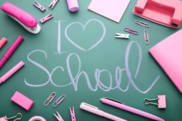 Inscription I Love School on chalkboard with school supplies