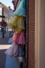 Colorful skirts hanging on the red brick wall on the blurred background