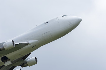 Close-up on a white cargo Boeing 747 taking off