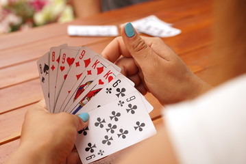 Female hold few playing cards