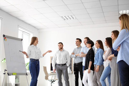 Female Business Trainer Giving Lecture In Office