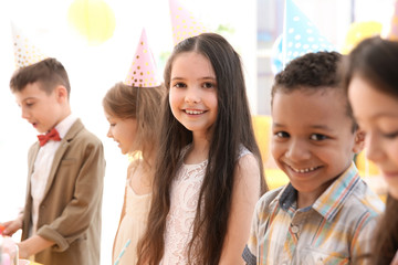 Cute little children at birthday party indoors