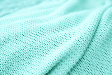 Texture of warm knitted mint blanket, closeup