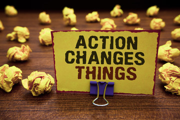 Naklejka premium Handwriting text writing Action Changes Things. Concept meaning doing something will reflect other things Reaction Yellow sticky card clipped text notice crumpled paper balls wood table.