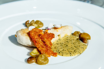 Fried chicken breast with mustard sauce, bread chips and mushrooms.