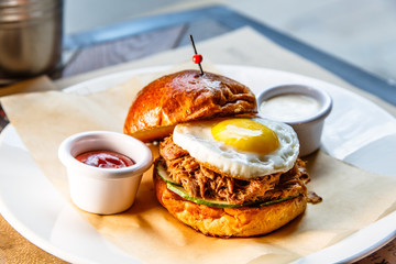 Burger with beef stew and egg lying on a plate