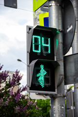 Green traffic light with colorful unfocused lights on a background