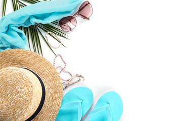Flat lay composition with stylish hat and beach objects on white background