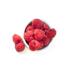 raspberry in white cup isolated on white