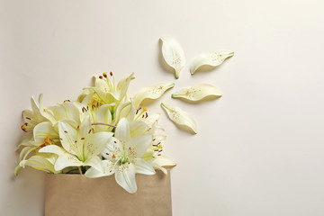 Flat lay composition with lily flowers on light background