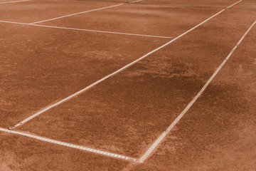 brown tennis court with white marking lines