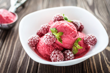 Delicious ice cream  made from fresh berries on a wooden background