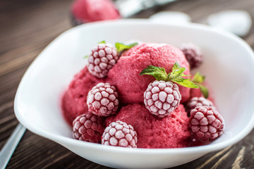 Delicious ice cream  made from fresh berries on a wooden background