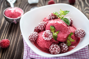 Delicious ice cream  made from fresh berries on a wooden background