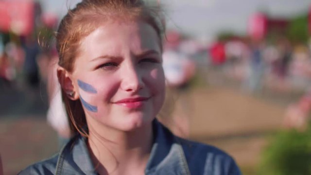 Close up view of young girl with Argentinian flag on cheek
