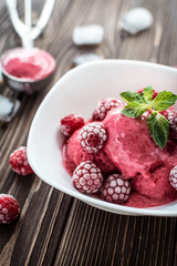 Delicious ice cream  made from fresh berries on a wooden background