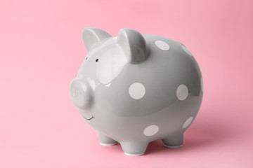 Gray piggy bank on color background. Money saving