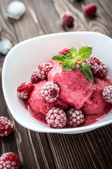 Delicious ice cream  made from fresh berries on a wooden background