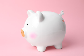 White piggy bank on color background. Money saving