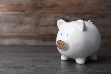 White piggy bank on gray table. Money saving