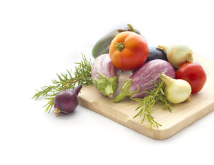 Summer veggies with wodden cutting board on white