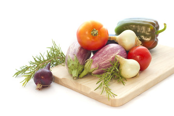 Summer veggies with wodden cutting board on white