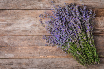 Lavender flowers on wooden background, top view