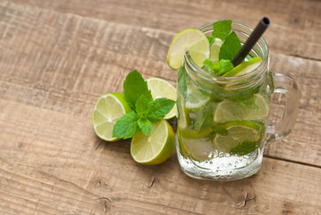 Summer Cold drink on a wooden table with mint and citrus Wooden Background