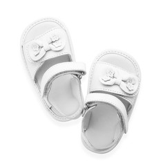 Pair of cute baby sandals decorated with bows on white background, top view