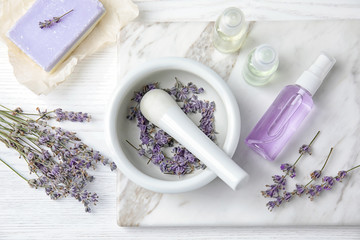 Fototapeta na wymiar Flat lay composition with lavender flowers and natural cosmetic products on wooden background