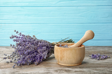 Mortar with lavender flowers on table. Ingredient for natural cosmetic