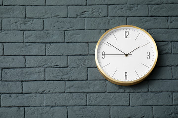 Fototapeta na wymiar Modern clock on brick wall. Time concept