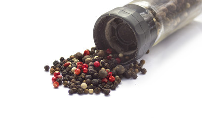 Black, red and white pepper isolated on white