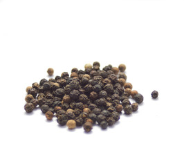 Stack of black pepper on white background