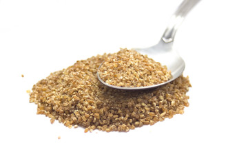 Stack of cereals whith spoon isolated on white