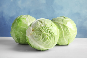 Whole cabbages on white table. Healthy food