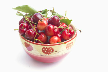 Cherries in a bowl on white