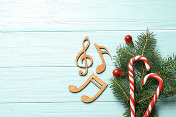 Flat lay composition with decorations and  notes on wooden background. Christmas music concept