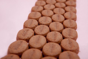 Cookies in the form of coffee on a pink background
