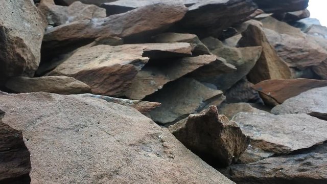 Crushed granite shattered in the explosion. Sharp edges of flat stones
