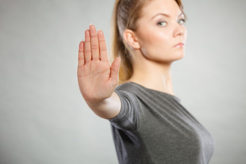 Assertive woman making stop gesture.