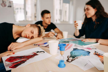 Bored sleepy designer sitting asleep at workplace, lazy man disinterested in boring routine, tired employee falling asleep at desk, lack of sleep