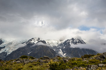 Clouds roll in over the snow covered alps in a mountain village