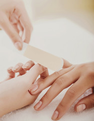 Beautician Polishing Nails of Female Customer.