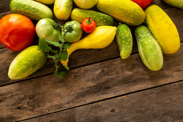 Garden fresh squash cucumber tomato onion pepper with background copy space