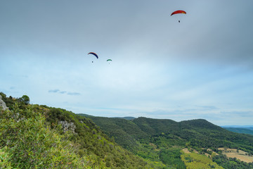 Fototapeta na wymiar Group of paragliders above mountains