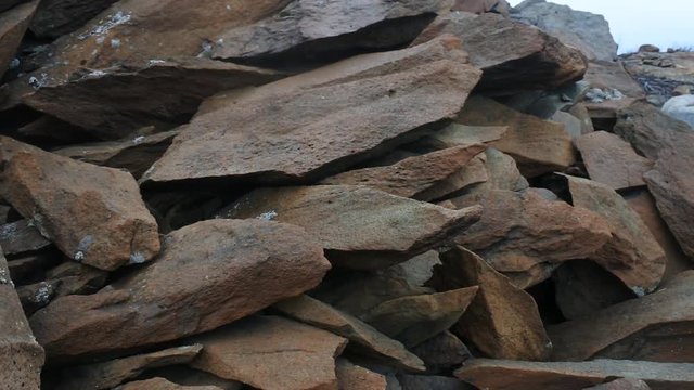 Crushed granite shattered in the explosion. Sharp edges of flat stones
